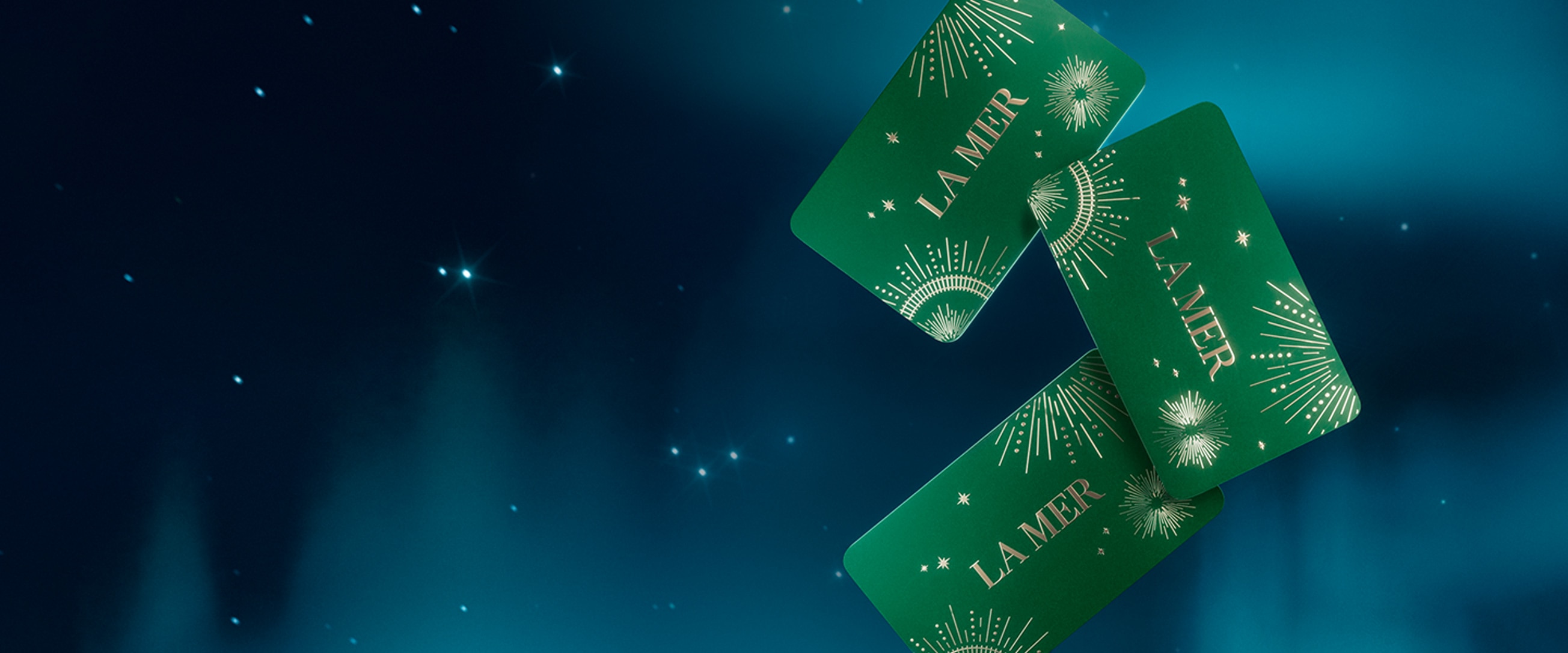 Group of La Mer holiday gift cards flying in a wintery, night sky