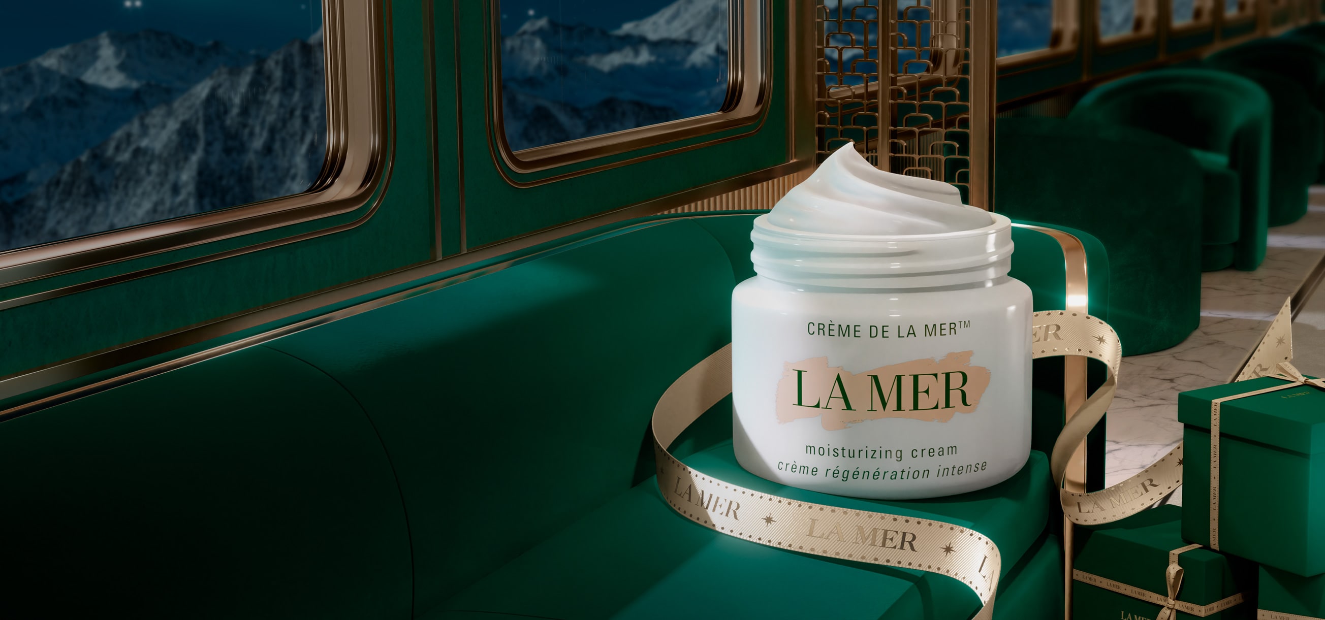 Crème de la Mer on a green velvet chair wrapped in a gold La Mer ribbon