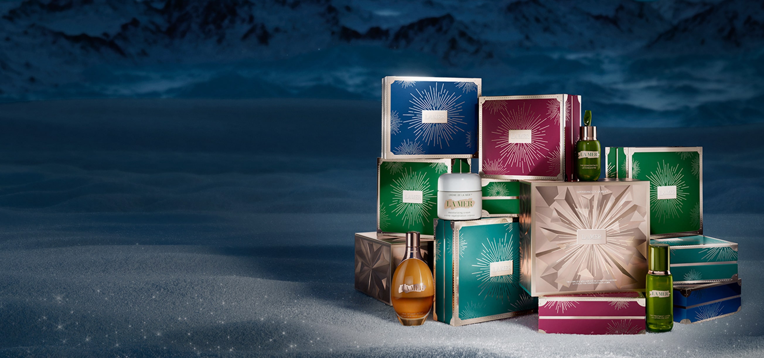 Selection of boxed La Mer Christmas gift sets stacked in a wintery oasis